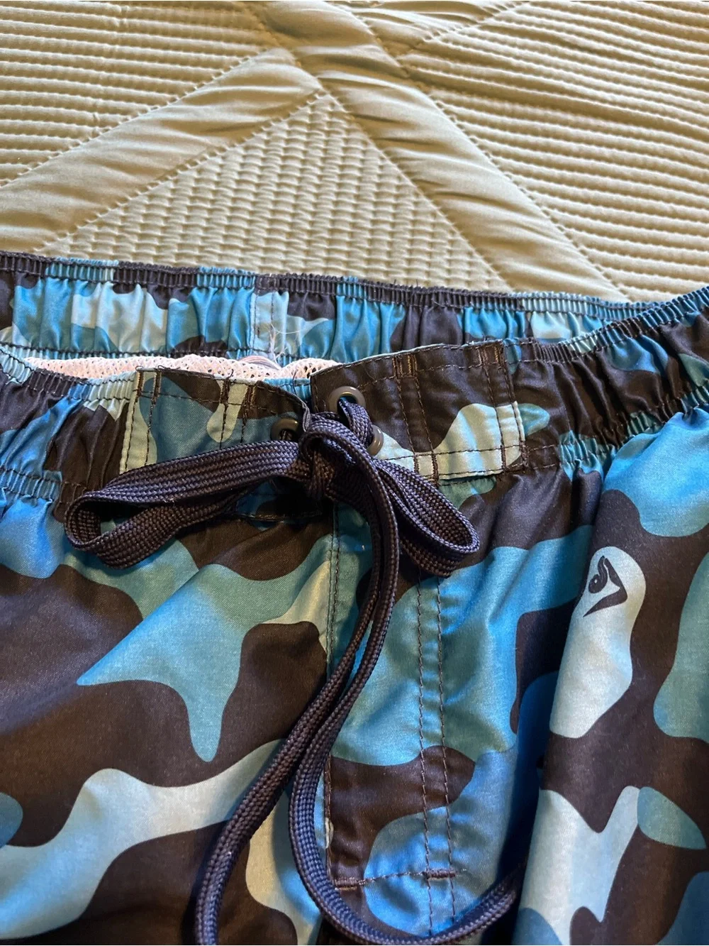 Pair of Kanu Surf Men's Blue Camo & Black Floral Swim Trunks